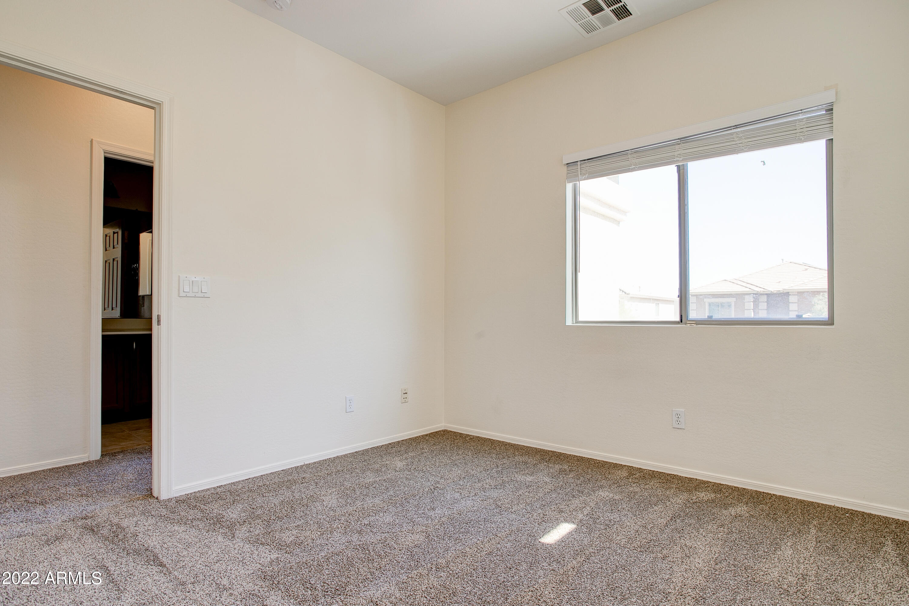 9928 West Chipman Road Tolleson, AZ 85353 - Photo 22 of 42 an empty room with a window