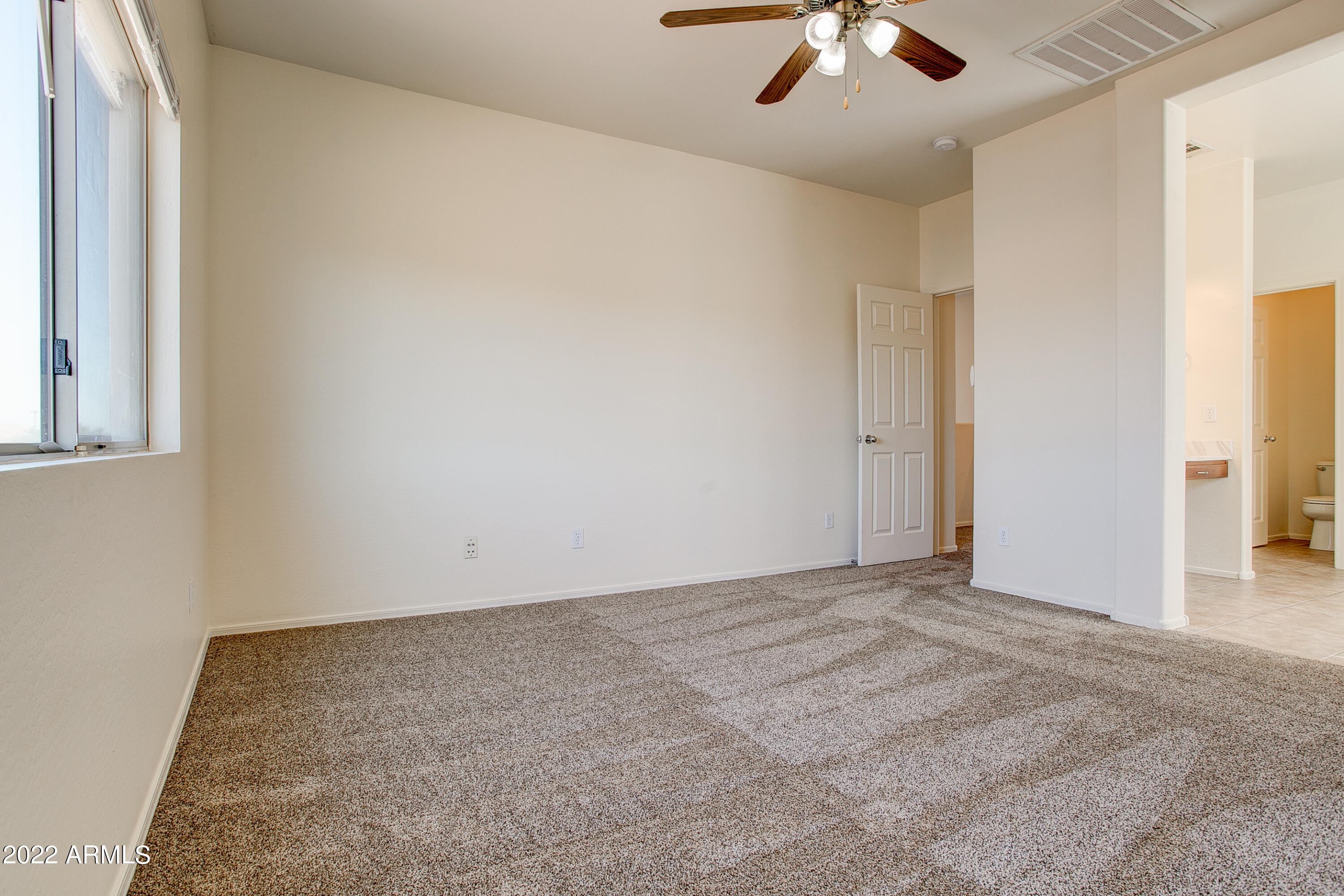 9928 West Chipman Road Tolleson, AZ 85353 - Photo 24 of 42 an empty room with chandelier fan