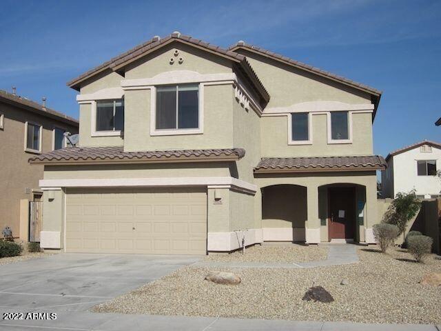 9928 West Chipman Road Tolleson, AZ 85353 - Photo 42 of 42 a front view of a house with a yard and garage