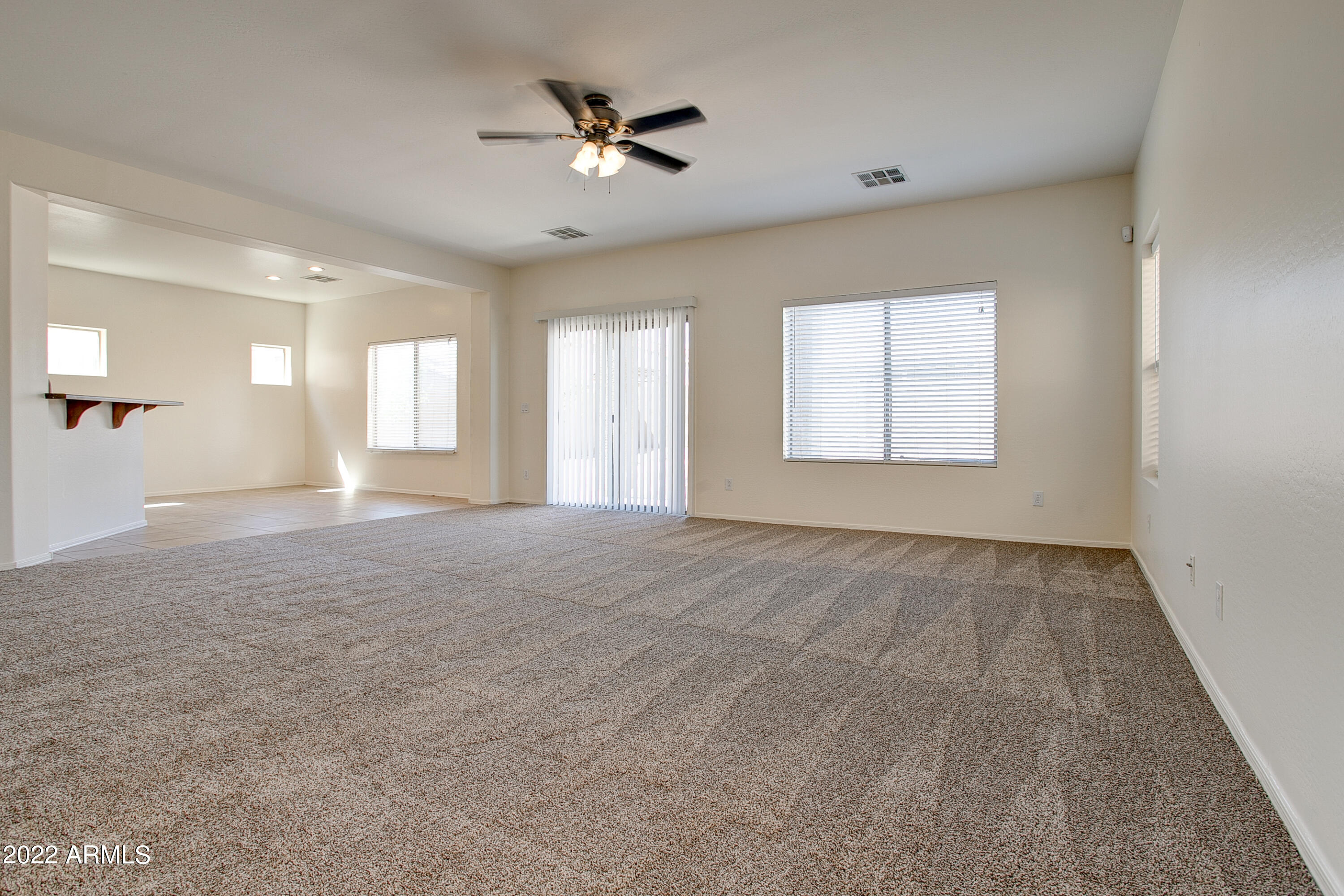 9928 West Chipman Road Tolleson, AZ 85353 - Photo 5 of 42 an empty room with windows and ceiling fan