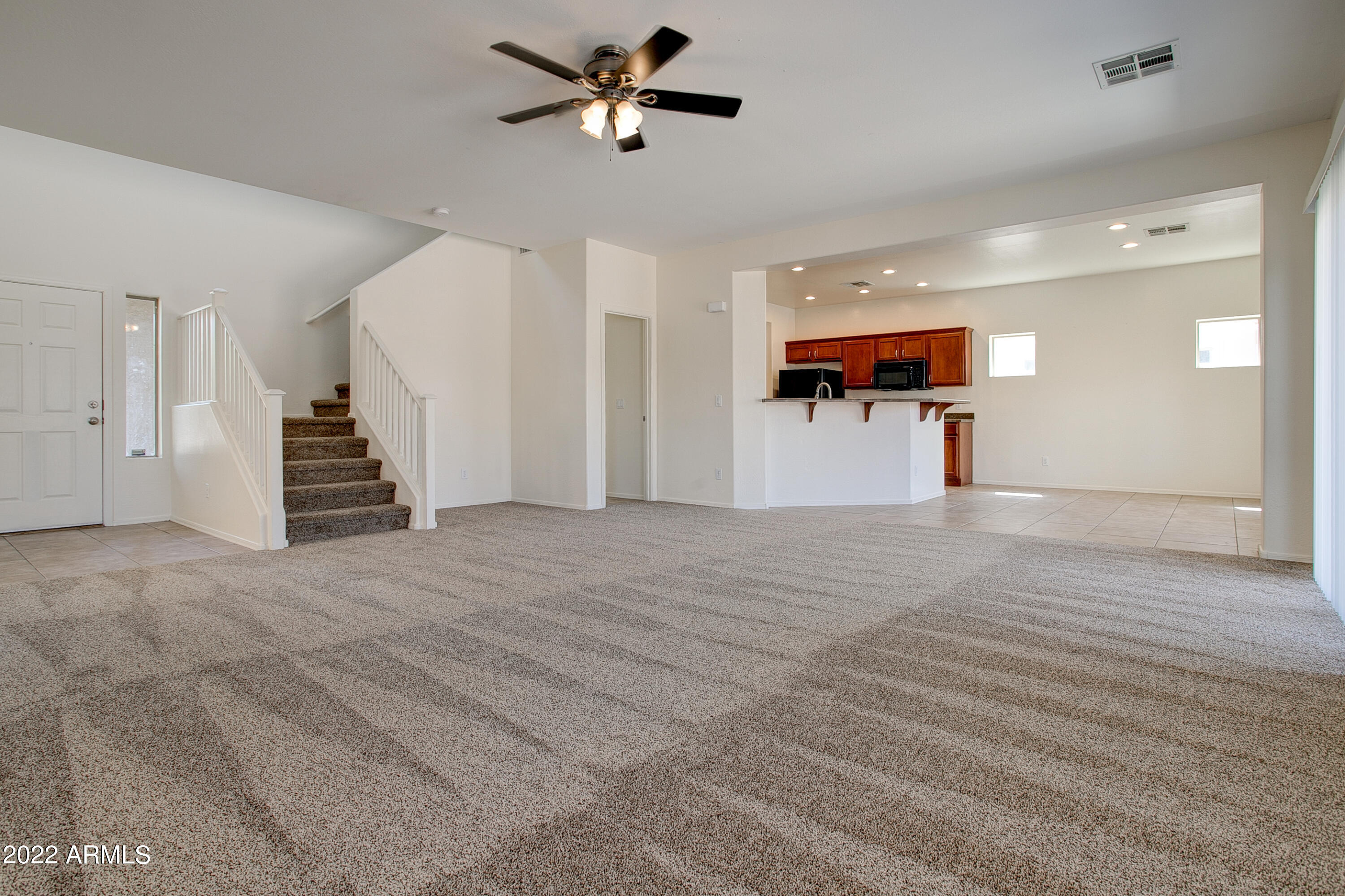 9928 West Chipman Road Tolleson, AZ 85353 - Photo 7 of 42 a view of a living room and a ceiling fan