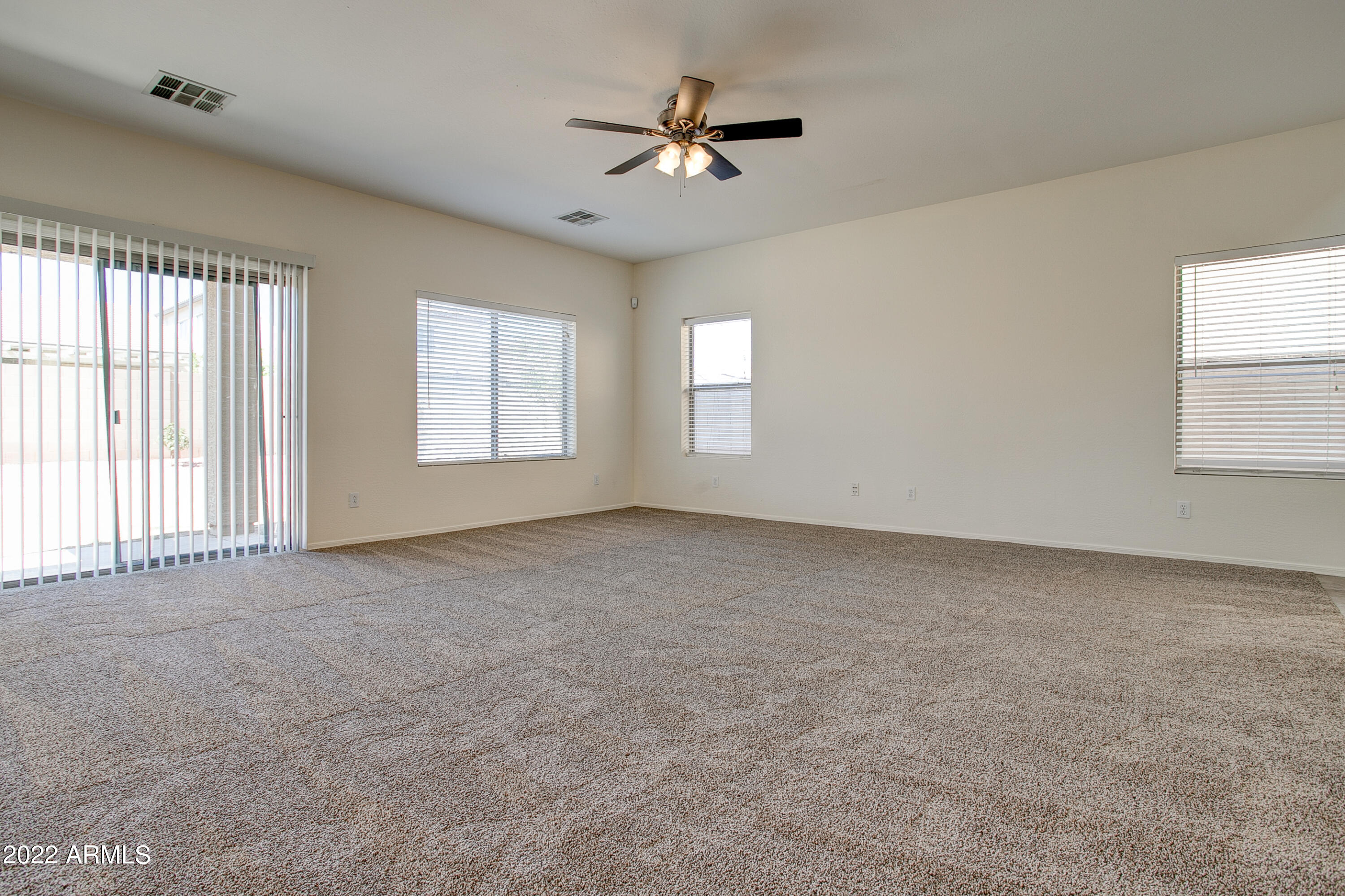 9928 West Chipman Road Tolleson, AZ 85353 - Photo 8 of 42 a view of a livingroom with a ceiling fan and window