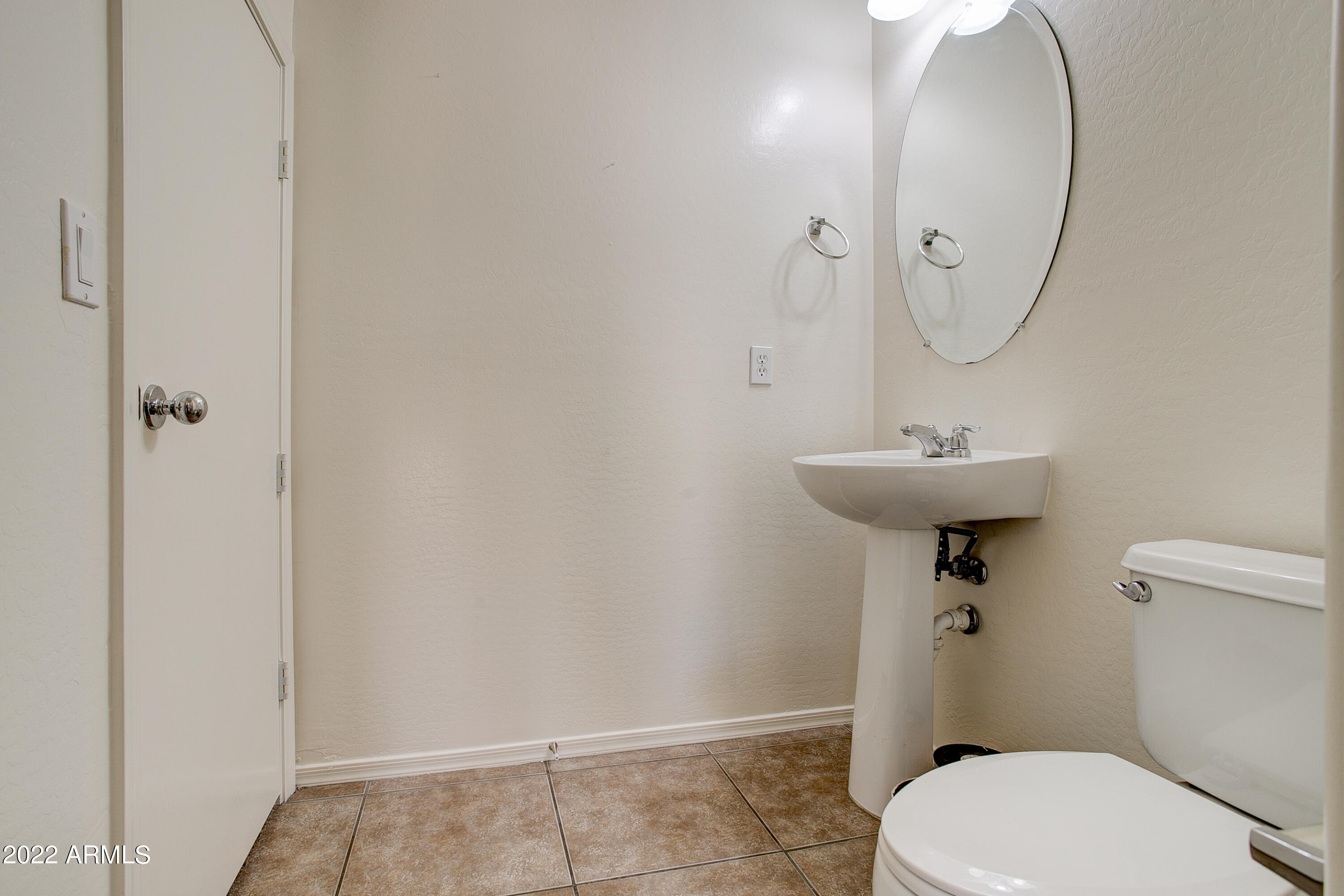9928 West Chipman Road Tolleson, AZ 85353 - Photo 9 of 42 a bathroom with a sink a toilet and shower