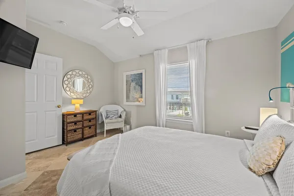 a bedroom with a bed a large mirror and a window