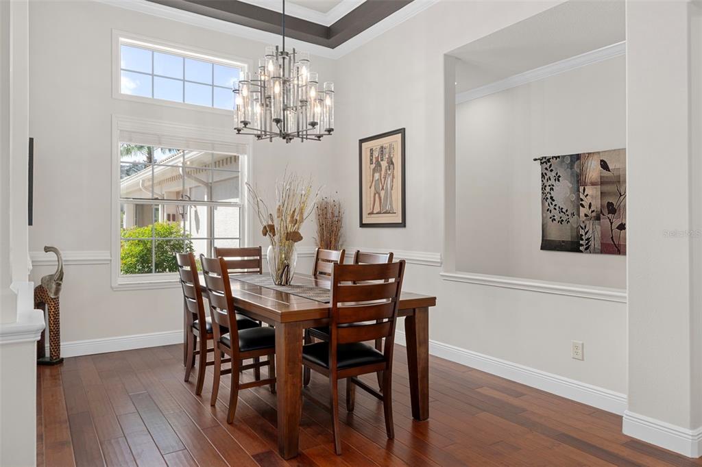 1601 North Tee Time Terrace Hernando, FL 34442 - Photo 21 of 69 a view of a dining room with furniture a chandelier and wooden floor