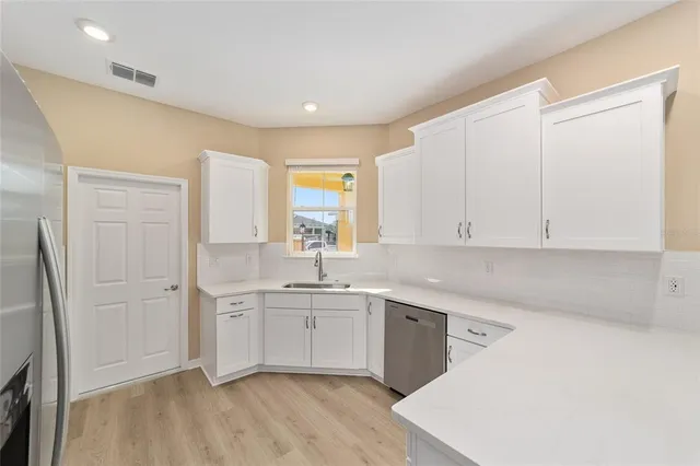 a view of a kitchen with sink and cabinets