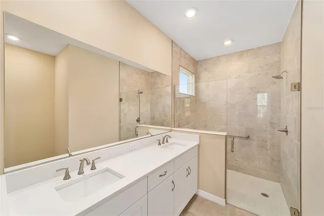 a bathroom with a shower sink and mirror