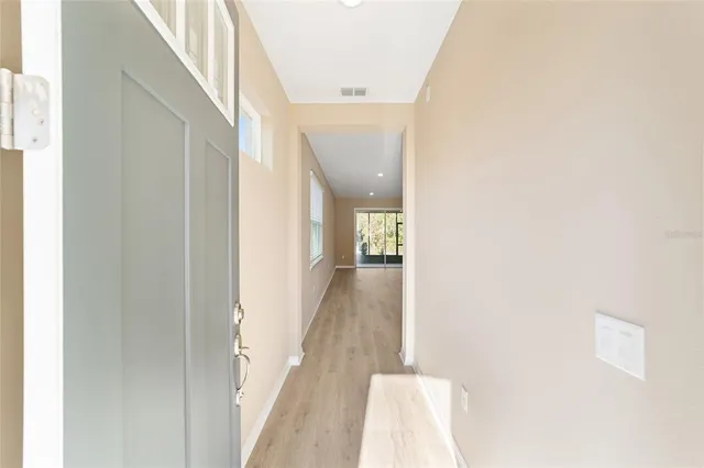 a view of a hallway with wooden floor