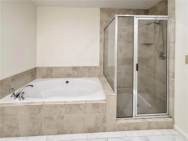 a bathroom with a bathtub and a shower
