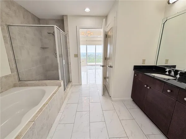 a spacious bathroom with a bathtub and a shower