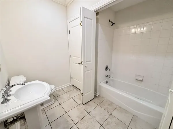 a spacious bathroom with a granite countertop sink toilet and bathtub