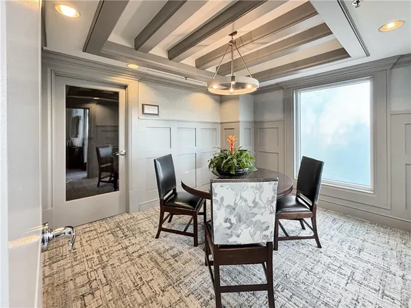 a view of a dining room with furniture and a chandelier