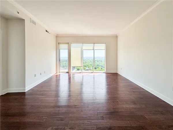 a view of wooden floor and windows in a room