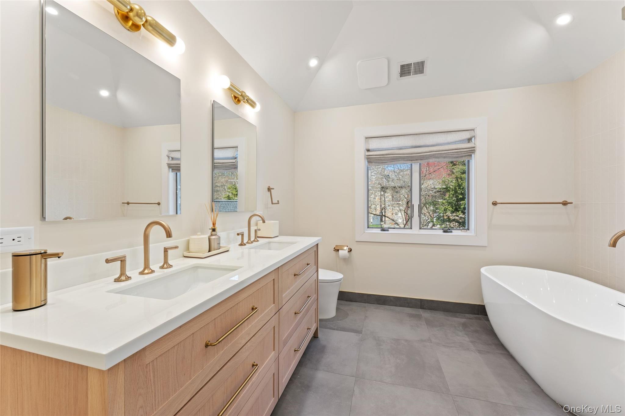 30 Corell Road Scarsdale, NY 10583 - Photo 17 of 32 Luxurious new primary bath with dual vanity, sleek custom cabinetry, and a spa-like soaking tub.