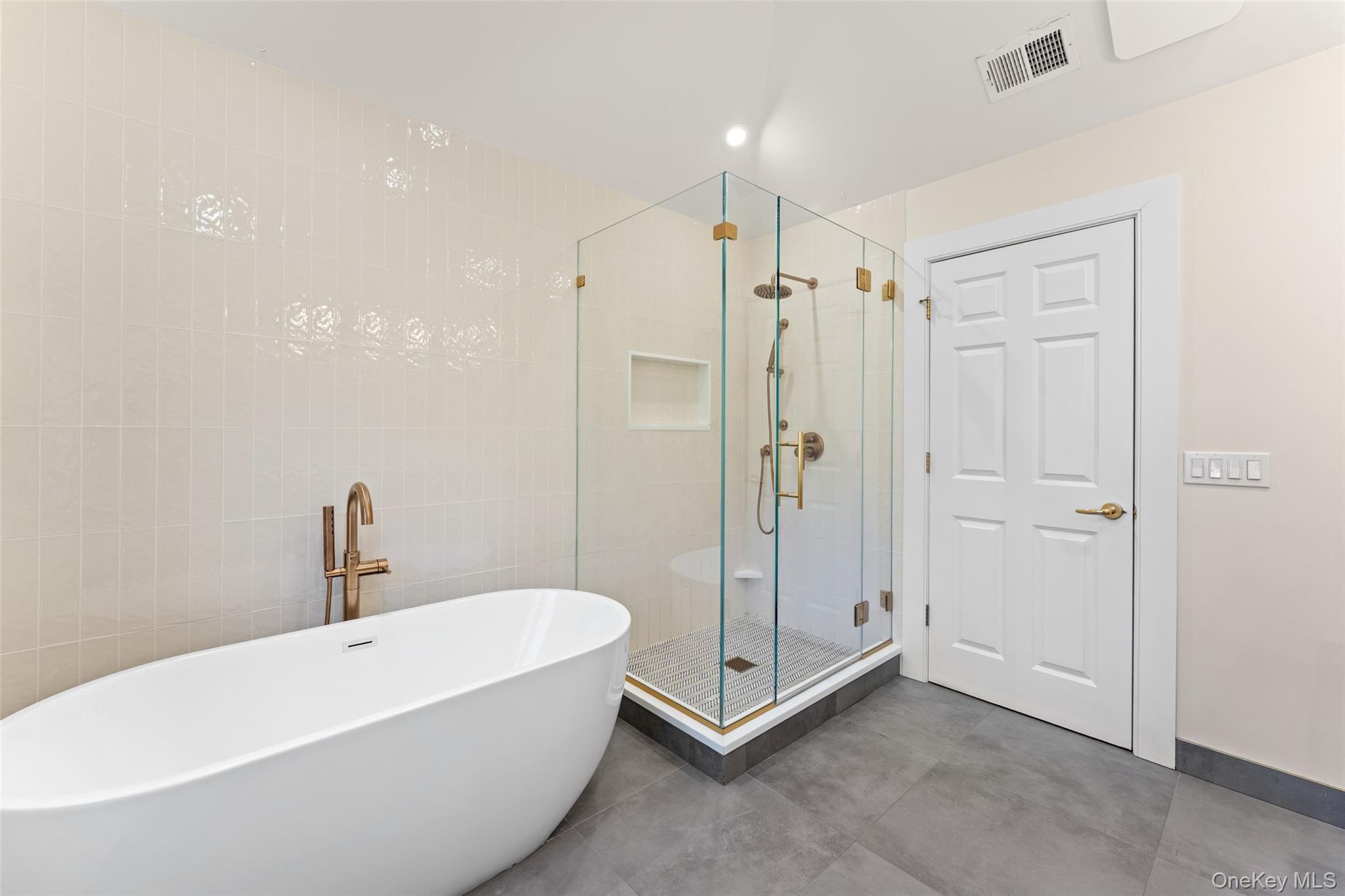 30 Corell Road Scarsdale, NY 10583 - Photo 18 of 32 Alternate view of primary bath with freestanding tub, glass-encased shower, and elevated designer finishes.