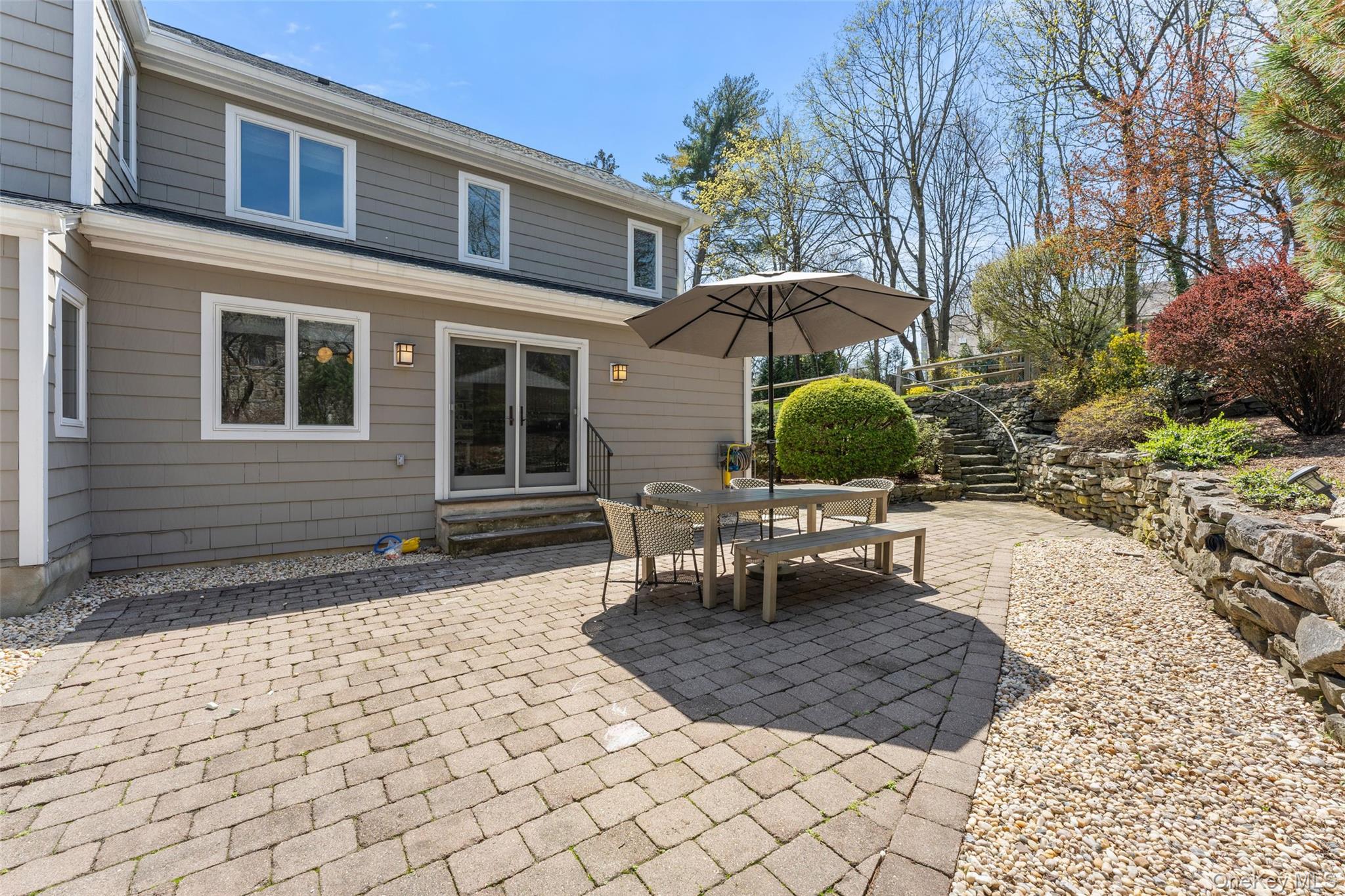 30 Corell Road Scarsdale, NY 10583 - Photo 27 of 32 Private rear patio surrounded by mature landscaping and terraced stonework. A peaceful outdoor retreat!