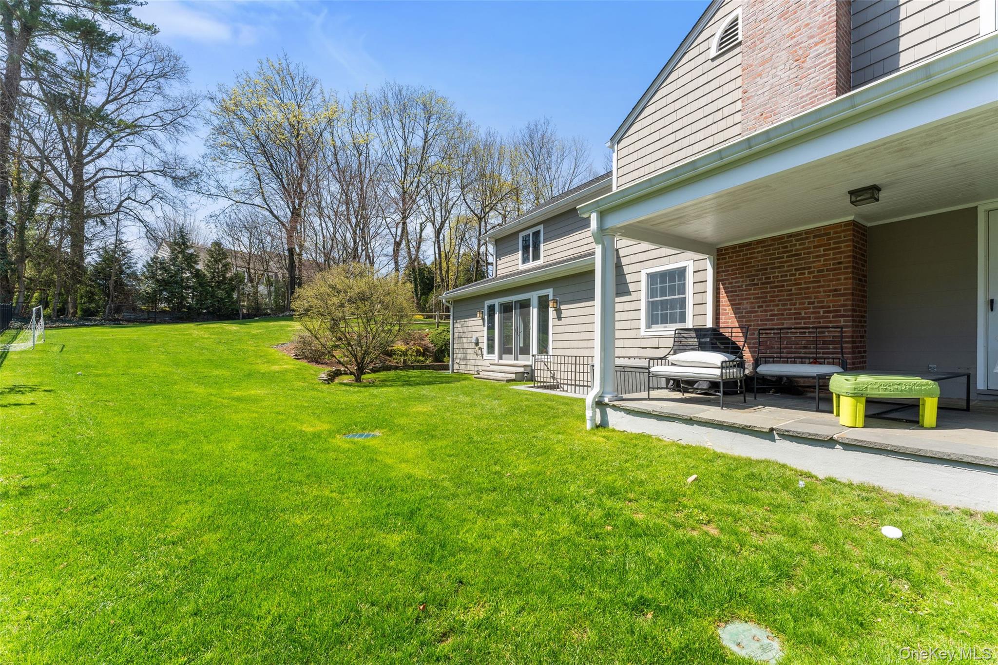 30 Corell Road Scarsdale, NY 10583 - Photo 28 of 32 Private yard with covered patio off the living room, open lawn, and wonderful space for outdoor enjoyment.