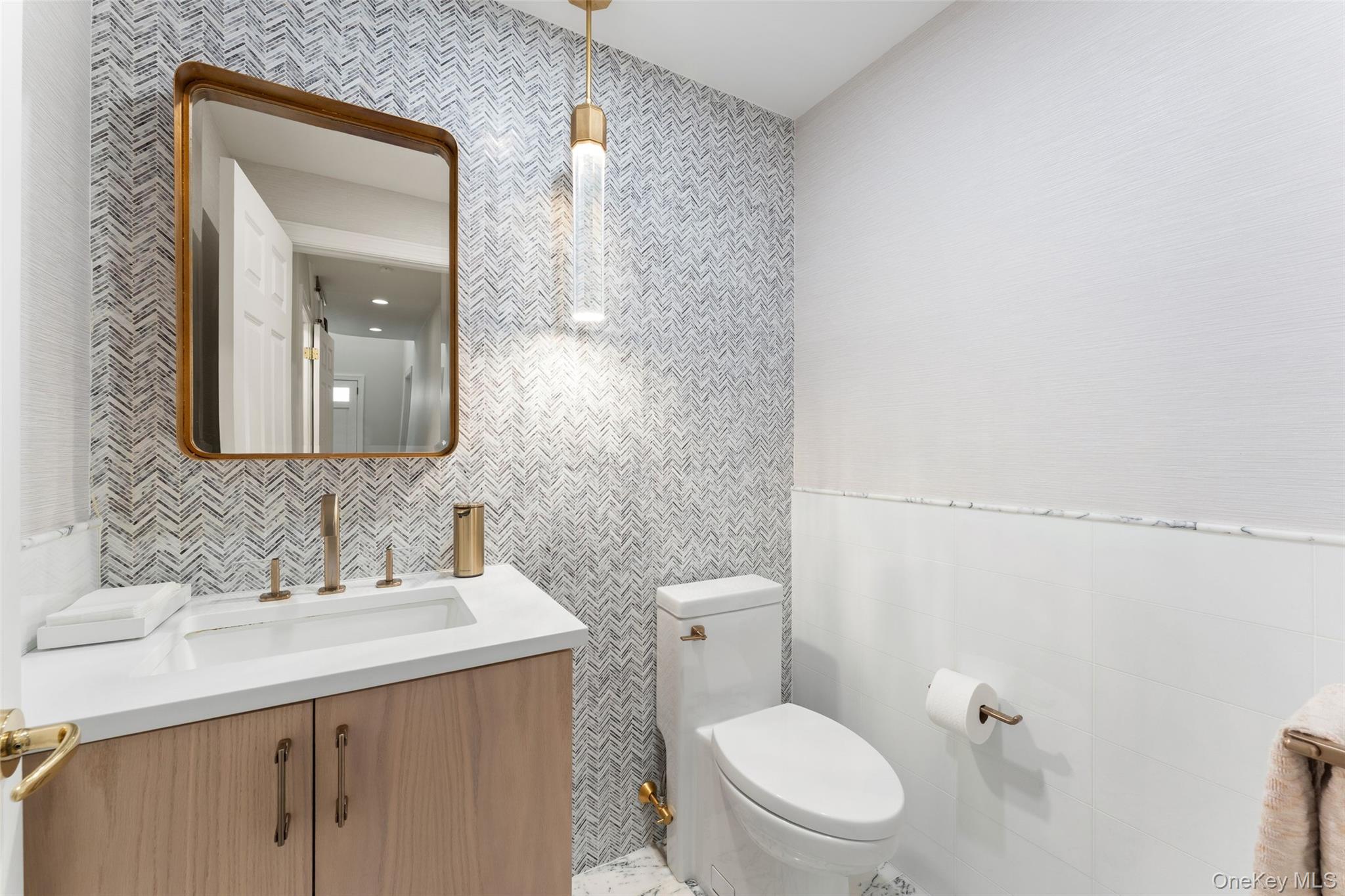 30 Corell Road Scarsdale, NY 10583 - Photo 5 of 32 Beautifully renovated powder room with designer wallpaper, refined fixtures, and a sophisticated modern finish.