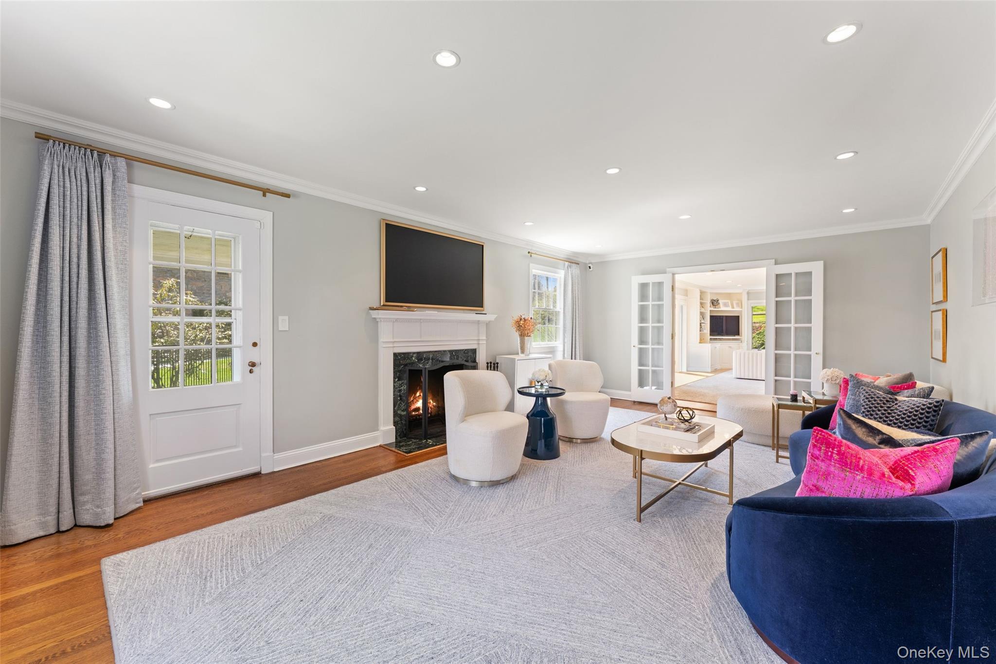 30 Corell Road Scarsdale, NY 10583 - Photo 6 of 32 Sophisticated living room featuring a fireplace, oversized windows, refined finishes and access to covered porch.