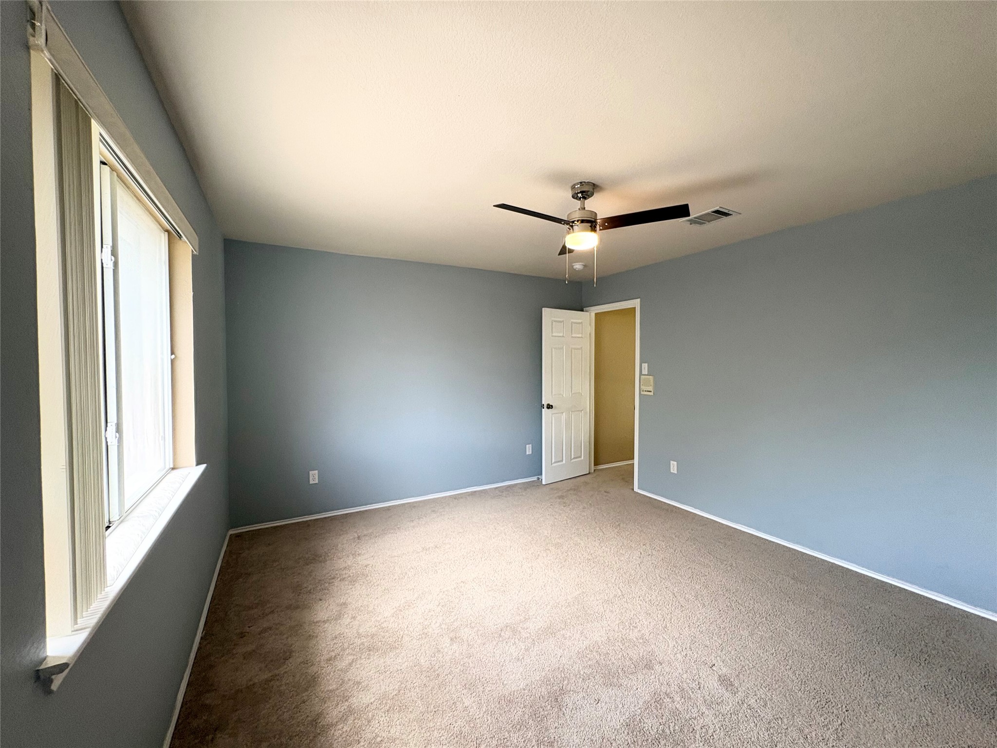 8103 Ephraim Road Austin, TX 78717 - Photo 24 of 35 A well-lit bedroom offering comfort and convenience with a ceiling fan.