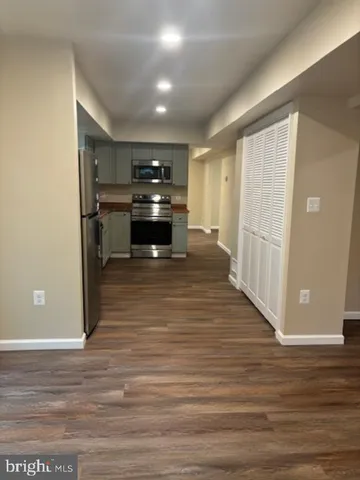 a kitchen with stainless steel appliances granite countertop a stove a refrigerator and a sink