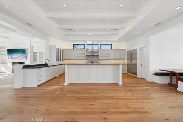 a view of a kitchen with a sink cabinets and wooden floor