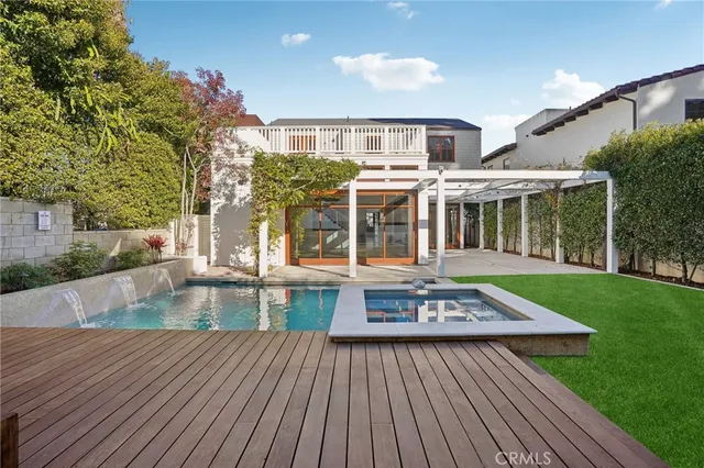 a large kitchen with stainless steel appliances granite countertop a lot of counter space and wooden floors