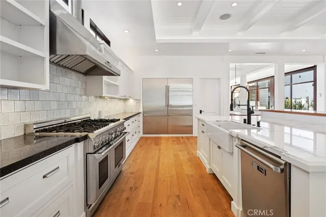 a kitchen with granite countertop a sink and cabinets