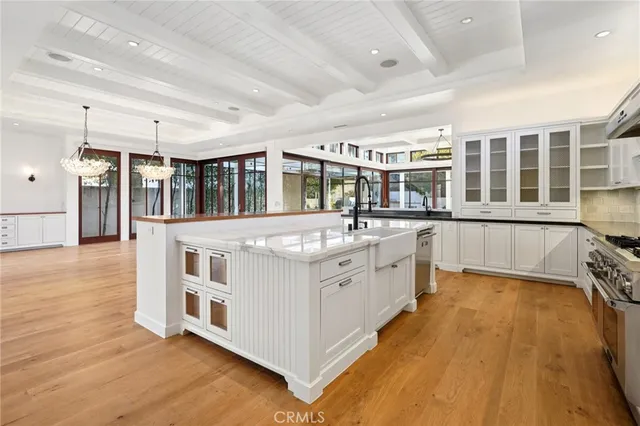 a kitchen with stainless steel appliances granite countertop a stove and white cabinets