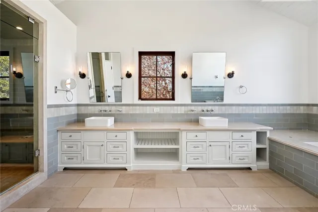 a spacious bathroom with a granite countertop sink mirror and shower