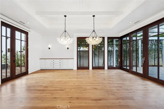 a view of an empty room with a fireplace and windows