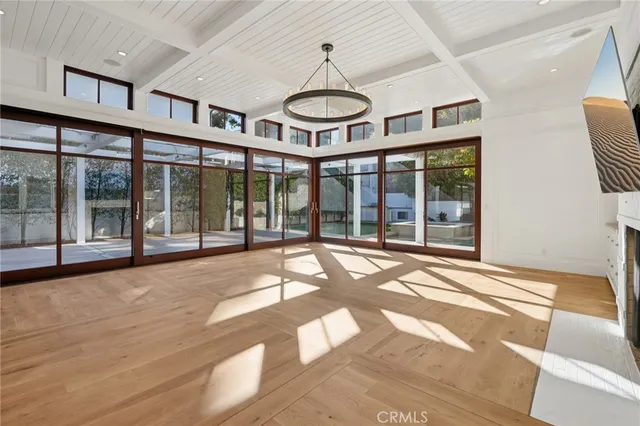 a view of a room with windows and ceiling fan