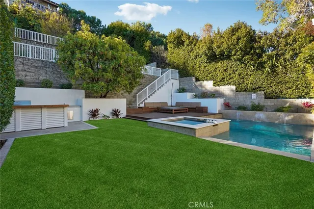 a view of a house with a backyard porch and sitting area