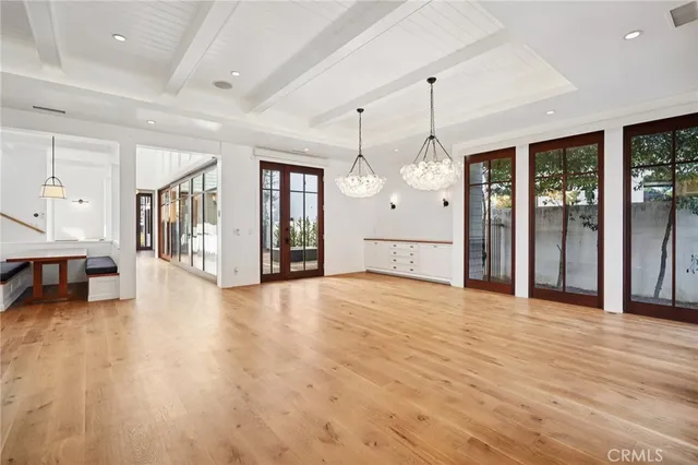 a large white kitchen with kitchen island a sink a stove and a refrigerator