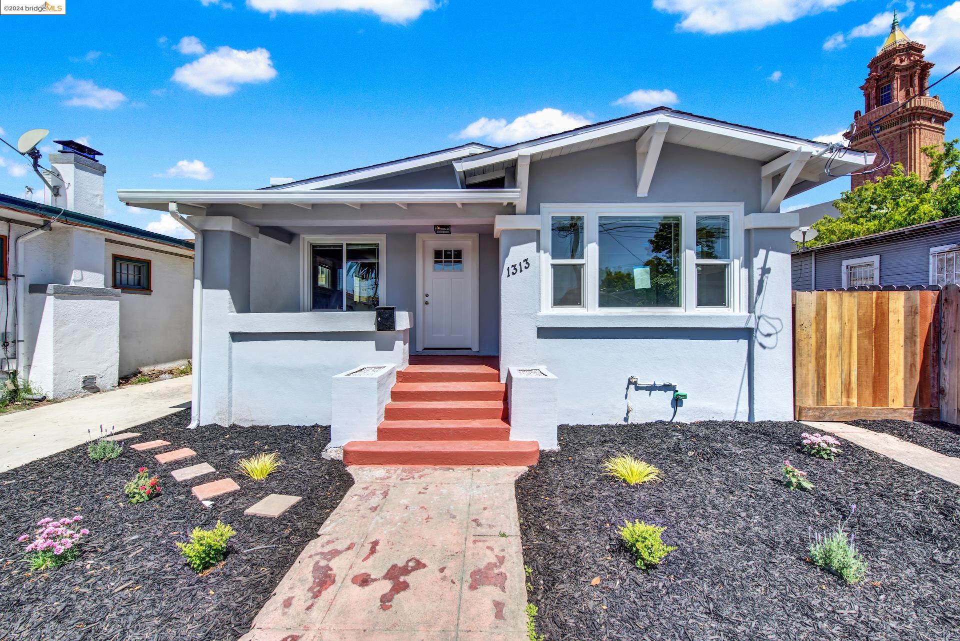 1313 58th Avenue Oakland, CA 94621 - Photo 1 of 1 a front view of a house with a yard