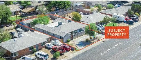 an aerial view of a house with a garden and mountain view in back