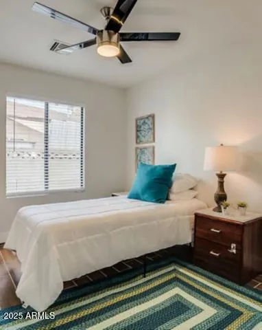 a bedroom with a bed and window