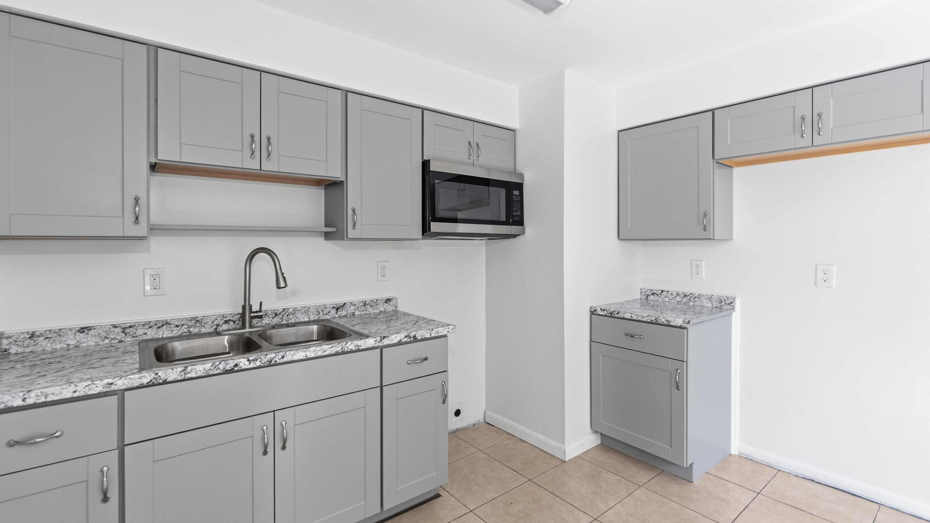 4453 Stevens Road Lake Worth Beach, FL 33461 - Photo 55 of 67 a kitchen with stainless steel appliances granite countertop a sink stove and microwave
