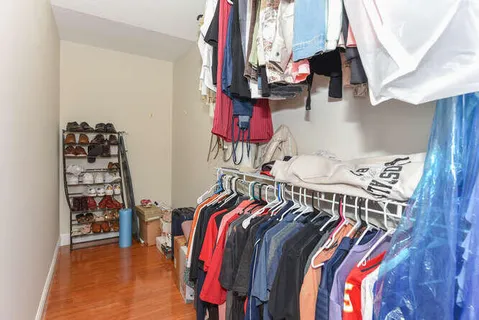 a view of walk in closet with clothes and shoes
