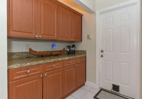 a kitchen with stainless steel appliances granite countertop white cabinets and a granite counter top
