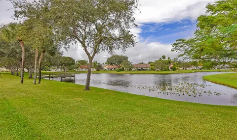 a view of a lake with houses in back