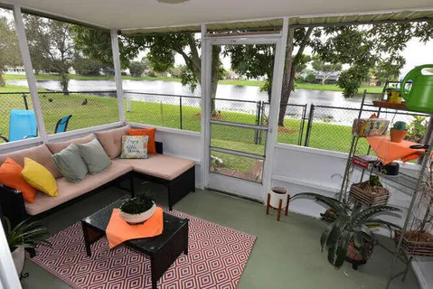 a balcony with furniture and a garden