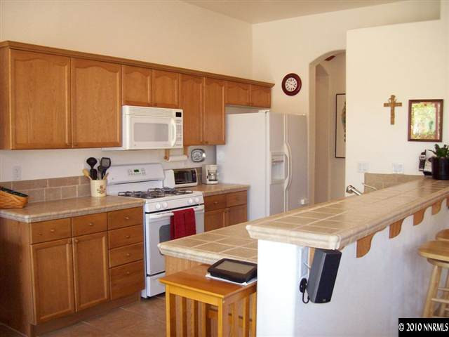 1845 Beringer Way Reno, NV 89521 - Photo 3 of 9 a kitchen with a stove a sink a refrigerator and a cabinets