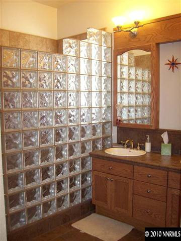 1845 Beringer Way Reno, NV 89521 - Photo 6 of 9 a bathroom with a double vanity sink a mirror and a shower