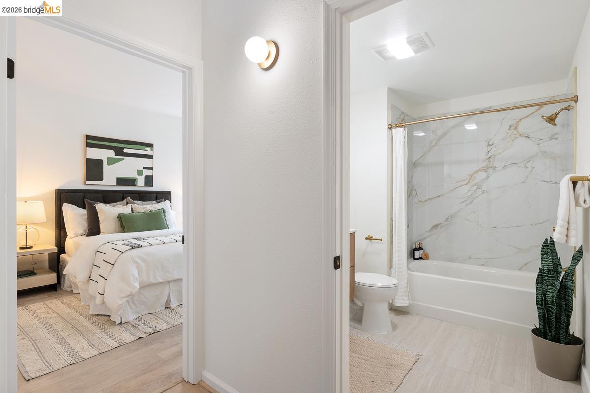 2029 Channing Way, Unit 3D Berkeley, CA 94704 - Photo 35 of 54 Well-appointed bathroom featuring a tub/shower combination with a gold-tone showerhead, a white marble-patterned surround, and gold-tone fixtures