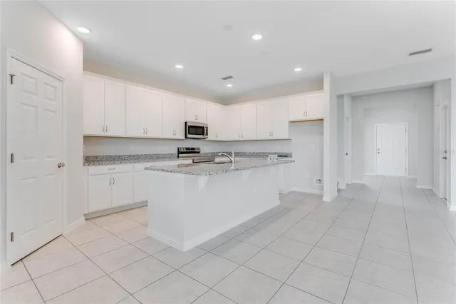a kitchen with cabinets and white stainless steel appliances
