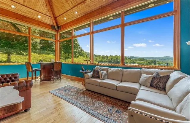 a balcony with furniture and a floor to ceiling window