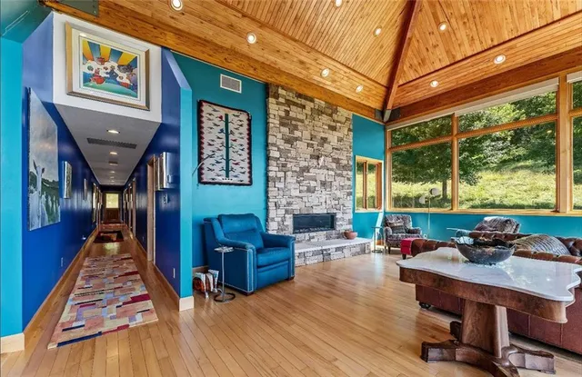 a living room with furniture fireplace and a large window