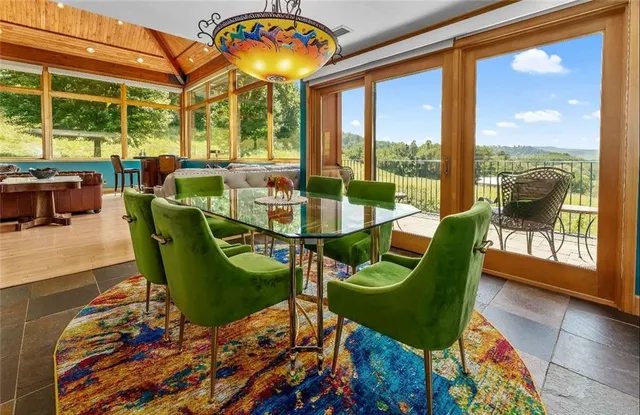 a dining room with furniture a rug and a chandelier