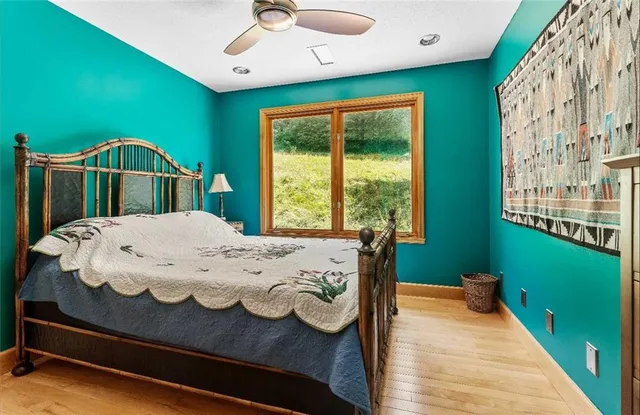 a bed sitting in a bedroom next to a window